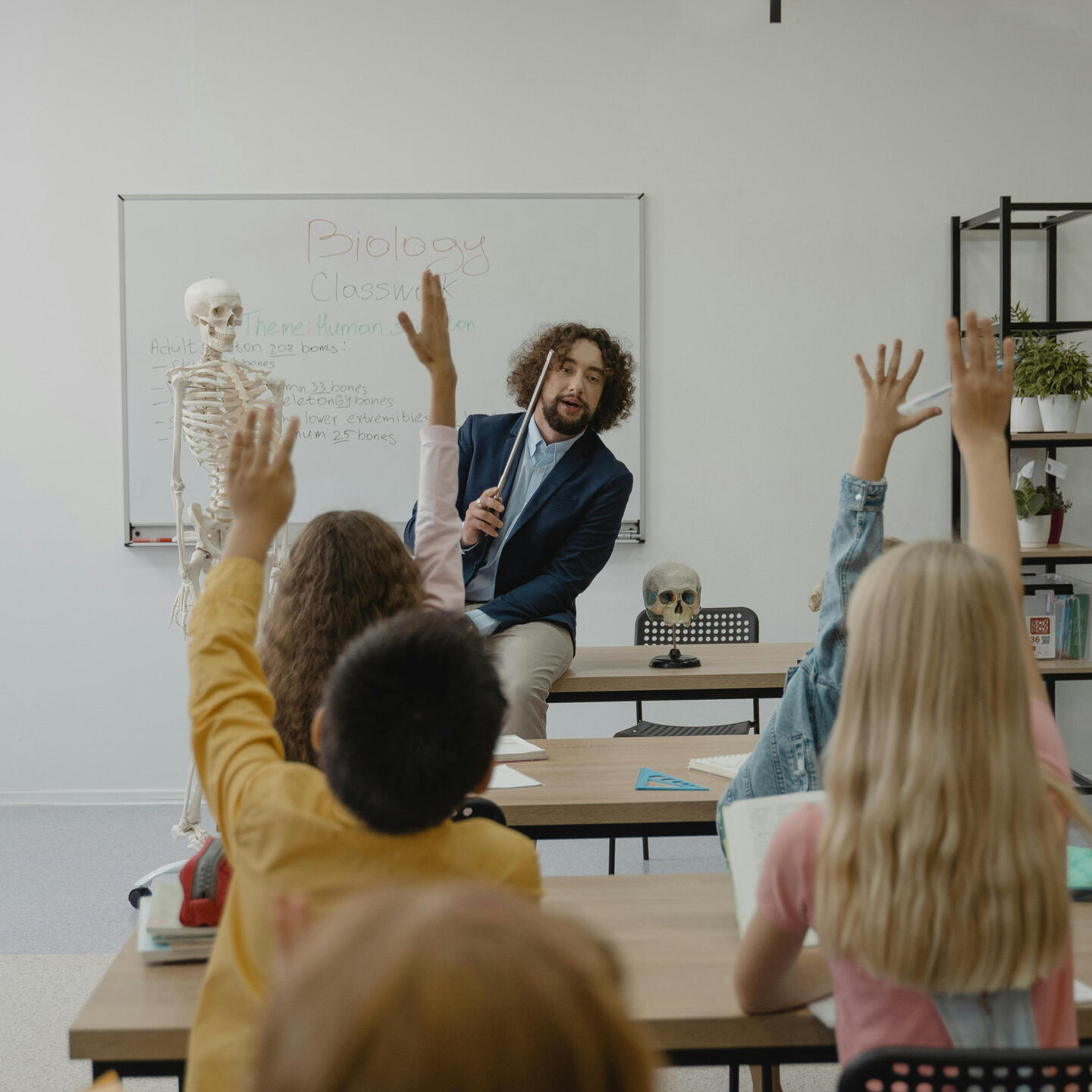 What is Peel Back Education? A teacher in the front of a classroom engaging with students.